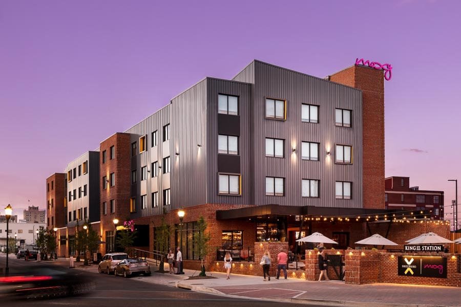 The Moxy Hotel in Chattanooga, Tennessee at dusk with lifestyle
